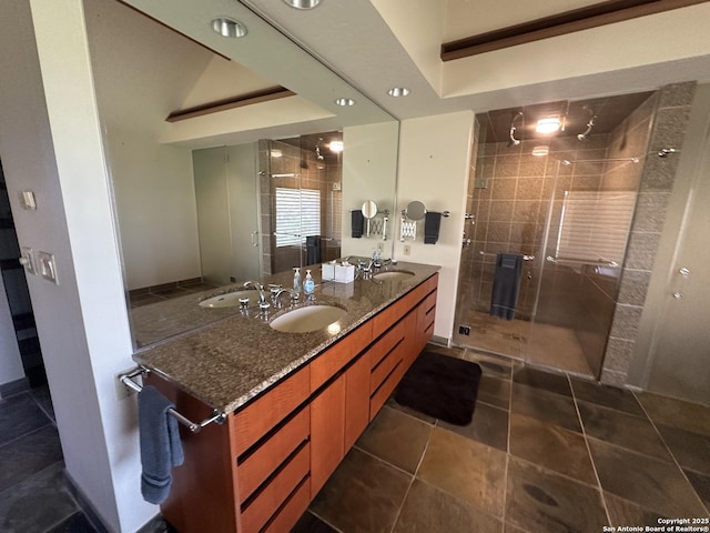 bathroom with tile patterned flooring, a shower stall, double vanity, and a sink