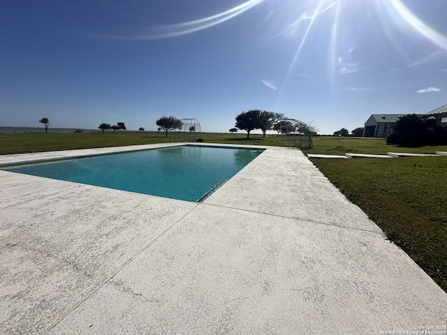 pool featuring a yard and a patio area
