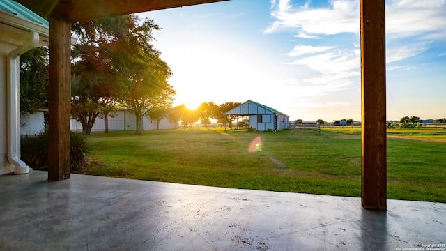 view of yard featuring an outdoor structure, a patio area, and fence