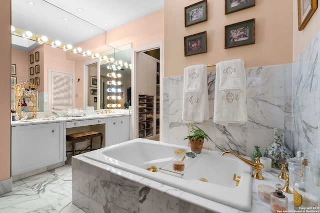 122 Chester Apt 5, San Antonio, TX 78209 - bathroom featuring vanity, a jetted tub, marble finish floors, and a chandelier