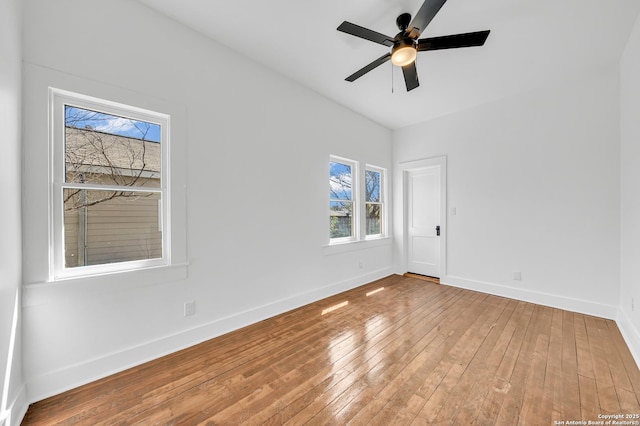 empty room featuring baseboards, wood-type flooring, and ceiling fan
