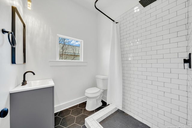 full bathroom featuring vanity, tile patterned floors, toilet, and a tile shower
