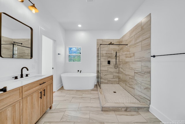 bathroom with vanity, a freestanding tub, recessed lighting, a stall shower, and marble finish floor