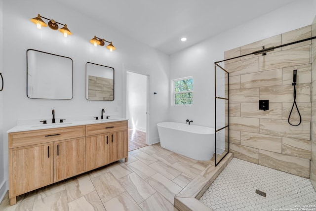 full bathroom with a sink, a freestanding tub, tiled shower, and double vanity
