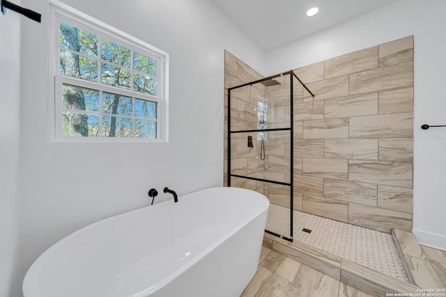 bathroom with a shower stall, a freestanding tub, recessed lighting, and marble finish floor