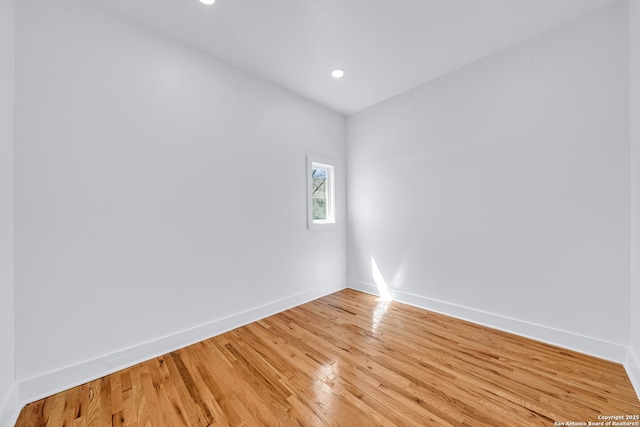 unfurnished room featuring recessed lighting, light wood-style floors, and baseboards