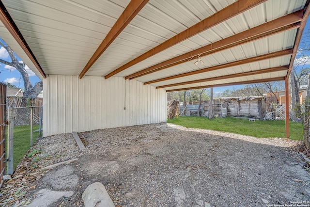 view of patio / terrace with an outbuilding and fence