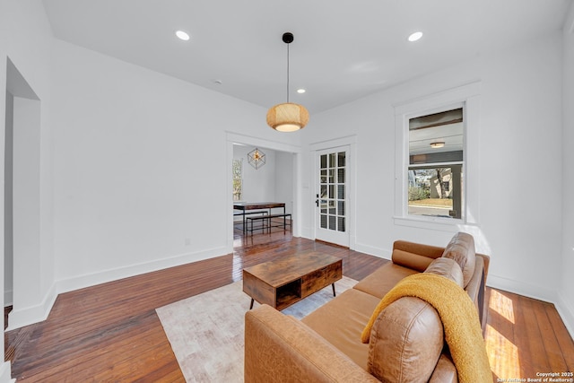 living area with recessed lighting, baseboards, and wood finished floors