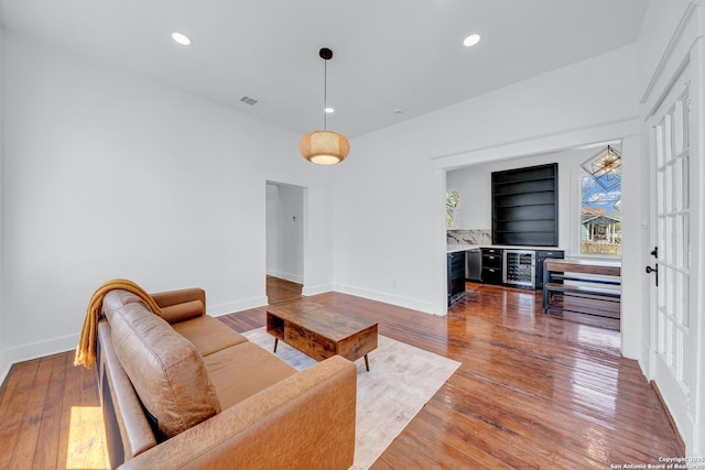 living room with hardwood / wood-style floors, recessed lighting, and baseboards