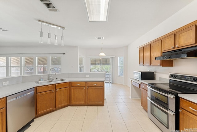 12319 Stable Road Dr, San Antonio, TX 78249 - kitchen with under cabinet range hood, stainless steel appliances, brown cabinets, and a sink