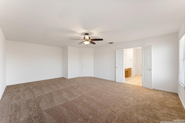 12319 Stable Road Dr, San Antonio, TX 78249 - interior space featuring visible vents, ensuite bathroom, a ceiling fan, baseboards, and light colored carpet