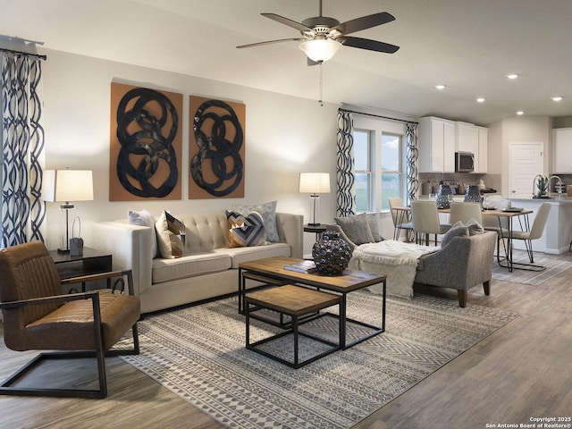 living room with recessed lighting, ceiling fan, and light wood-style floors