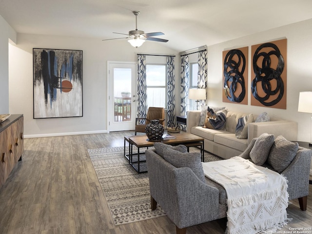living area with vaulted ceiling, baseboards, a ceiling fan, and wood finished floors