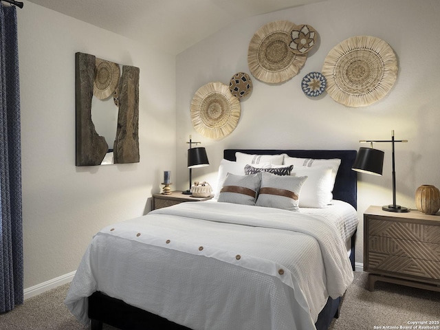 carpeted bedroom featuring lofted ceiling and baseboards