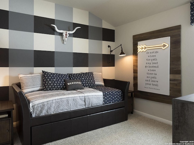 carpeted bedroom with baseboards and vaulted ceiling