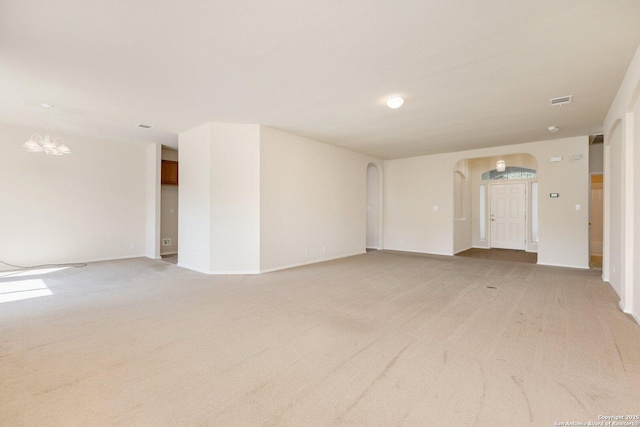 14204 Auberry, Helotes, TX 78023 - unfurnished room with arched walkways, light colored carpet, a chandelier, and baseboards