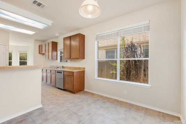 14204 Auberry, Helotes, TX 78023 - kitchen featuring dishwasher, brown cabinetry, light countertops, and baseboards