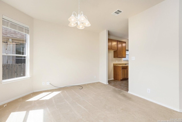 14204 Auberry, Helotes, TX 78023 - unfurnished dining area with light colored carpet, a chandelier, and baseboards