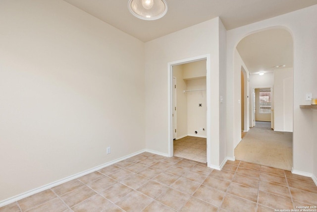 14204 Auberry, Helotes, TX 78023 - empty room with arched walkways, light tile patterned floors, and baseboards