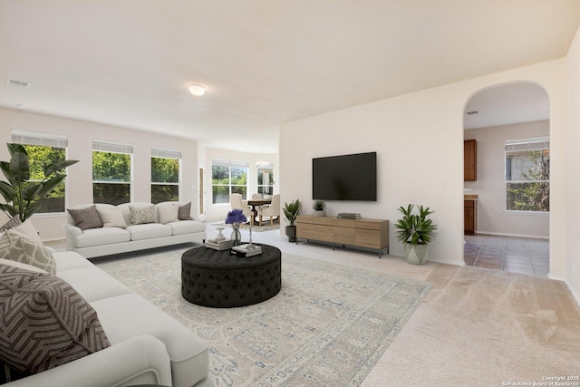 14204 Auberry, Helotes, TX 78023 - living room featuring arched walkways, carpet floors, and baseboards