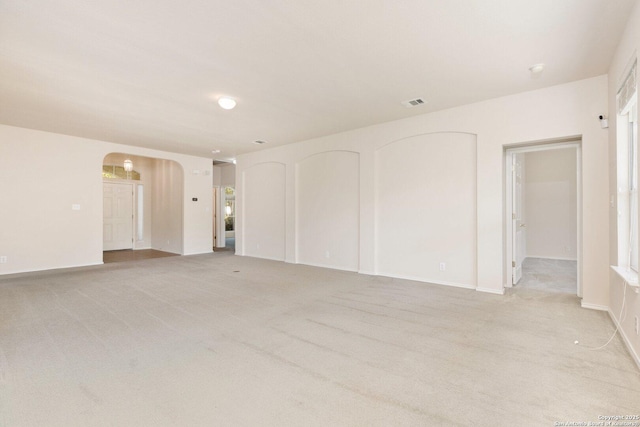 14204 Auberry, Helotes, TX 78023 - unfurnished room featuring arched walkways, light colored carpet, and baseboards