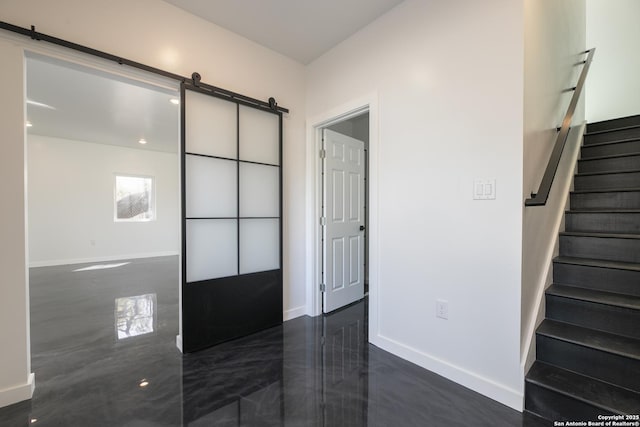 106 Bank St Unit 201, San Antonio, TX 78204 - entrance foyer with a barn door, stairway, and baseboards