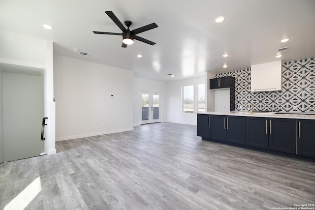 106 Bank St Unit 201, San Antonio, TX 78204 - unfurnished living room featuring light wood-type flooring, visible vents, recessed lighting, french doors, and ceiling fan