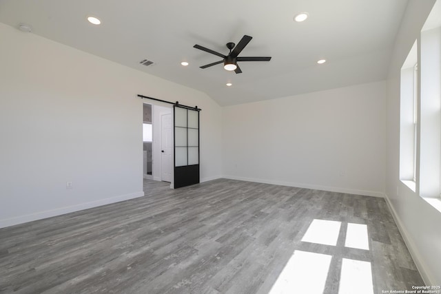 106 Bank St Unit 201, San Antonio, TX 78204 - empty room featuring wood finished floors, a ceiling fan, visible vents, recessed lighting, and a barn door