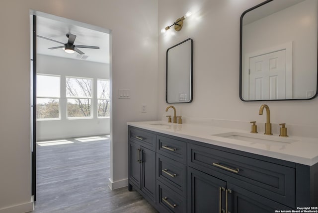 106 Bank St Unit 201, San Antonio, TX 78204 - bathroom featuring a sink, wood finished floors, ceiling fan, and double vanity