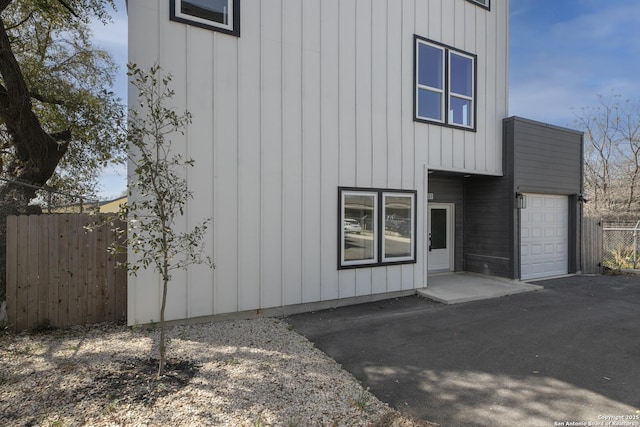 106 Bank St Unit 201, San Antonio, TX 78204 - view of front of home featuring board and batten siding, fence, a garage, and driveway