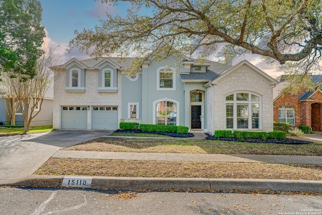 15110 Grayoak Frst, San Antonio, TX 78248 - view of front of house with stucco siding, stone siding, roof with shingles, concrete driveway, and a garage