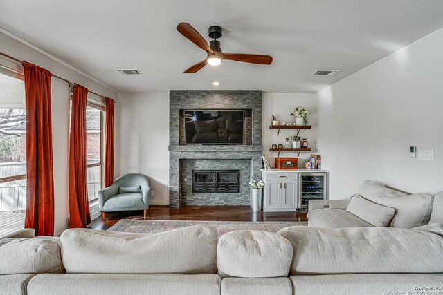 15110 Grayoak Frst, San Antonio, TX 78248 - living area with beverage cooler, visible vents, ceiling fan, and wood finished floors