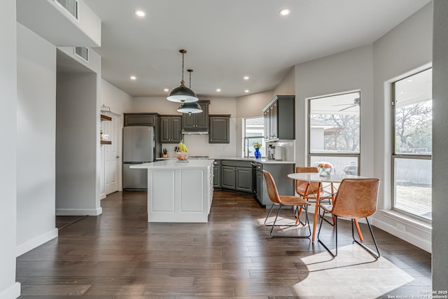 15110 Grayoak Frst, San Antonio, TX 78248 - kitchen with gray cabinetry, a center island, light countertops, freestanding refrigerator, and dark wood-style floors