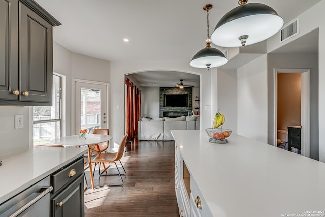 15110 Grayoak Frst, San Antonio, TX 78248 - kitchen with visible vents, light countertops, arched walkways, a ceiling fan, and dark wood-style flooring