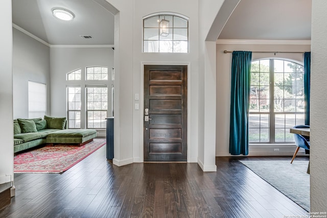 15110 Grayoak Frst, San Antonio, TX 78248 - entrance foyer with arched walkways, a healthy amount of sunlight, dark wood-style floors, and crown molding
