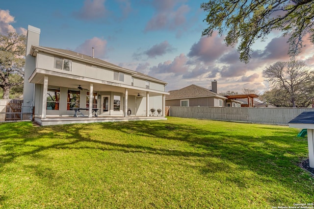 15110 Grayoak Frst, San Antonio, TX 78248 - back of house featuring a fenced backyard, stucco siding, ceiling fan, a patio area, and a lawn