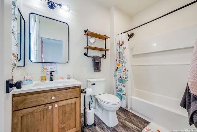 bathroom with vanity, toilet, wood finished floors, and shower / bath combo