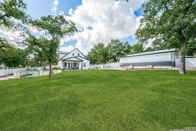 view of yard featuring a fenced in pool and a fenced backyard