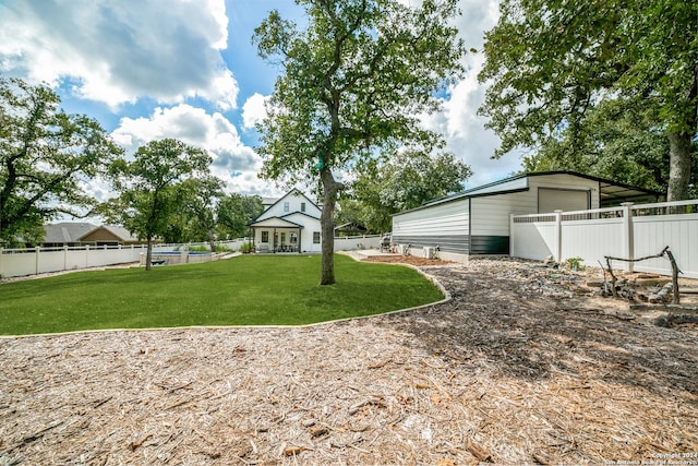 view of yard featuring a garage and fence