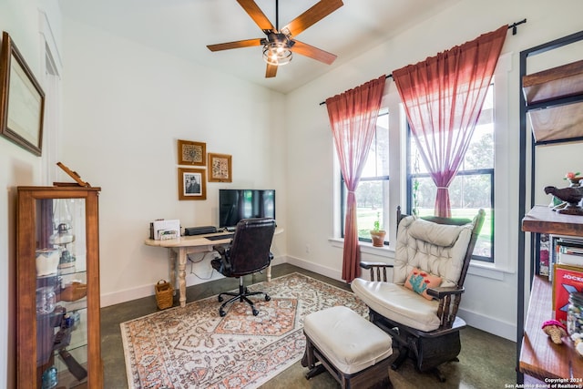 office area with a ceiling fan and baseboards