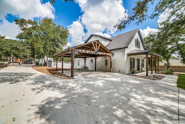 view of home's exterior with driveway and a shingled roof