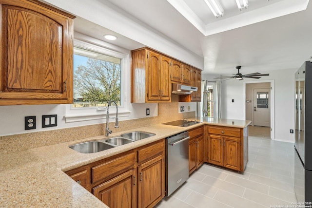 kitchen featuring a sink, under cabinet range hood, a peninsula, brown cabinetry, and dishwasher