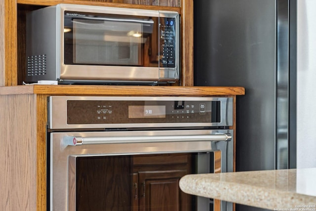 details with stainless steel appliances and light stone countertops