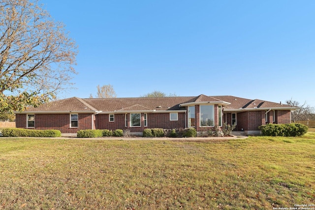 single story home featuring brick siding and a front yard