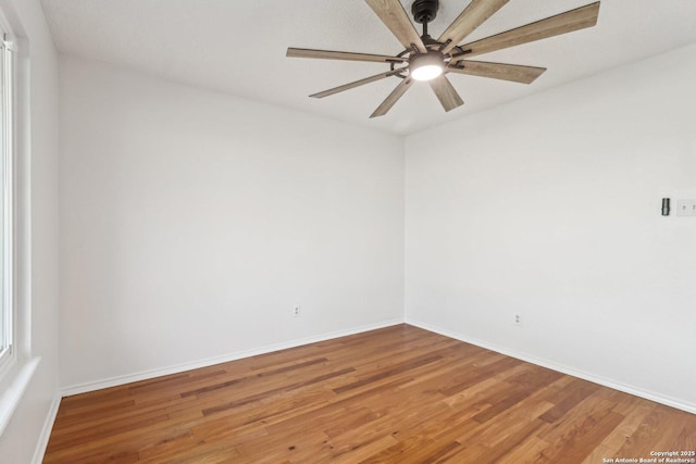 empty room featuring baseboards and light wood-type flooring