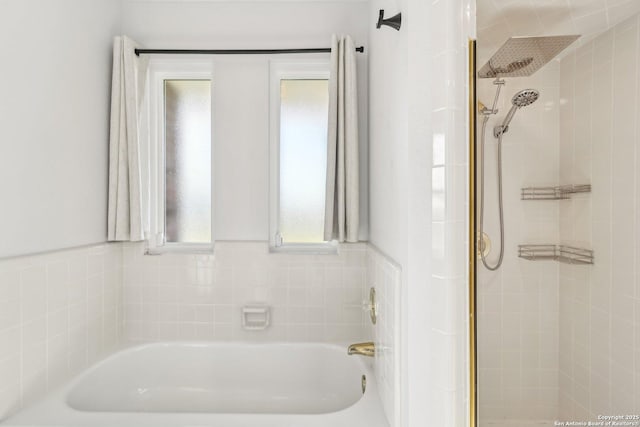 full bathroom with a bath and a tile shower