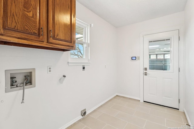 clothes washing area featuring hookup for a washing machine, plenty of natural light, cabinet space, and electric dryer hookup