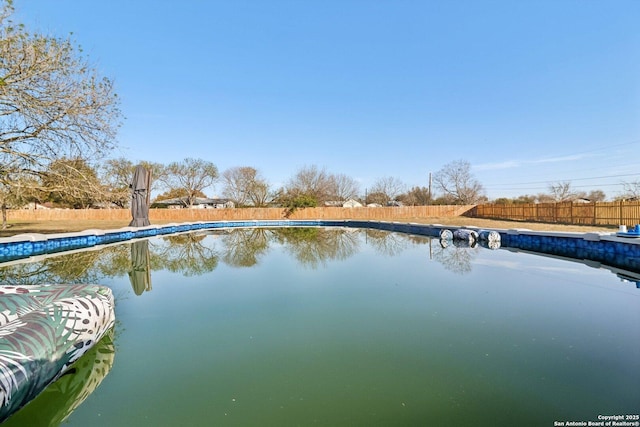 view of water feature with fence