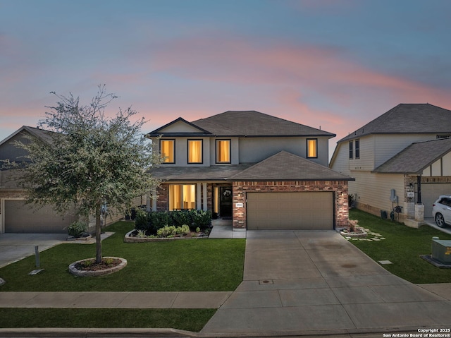 view of front of home featuring brick siding, concrete driveway, a lawn, and a garage