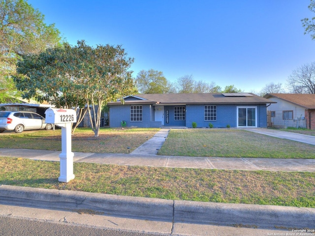 12226 La Barca, San Antonio, TX 78233 - ranch-style home with roof mounted solar panels and a front yard